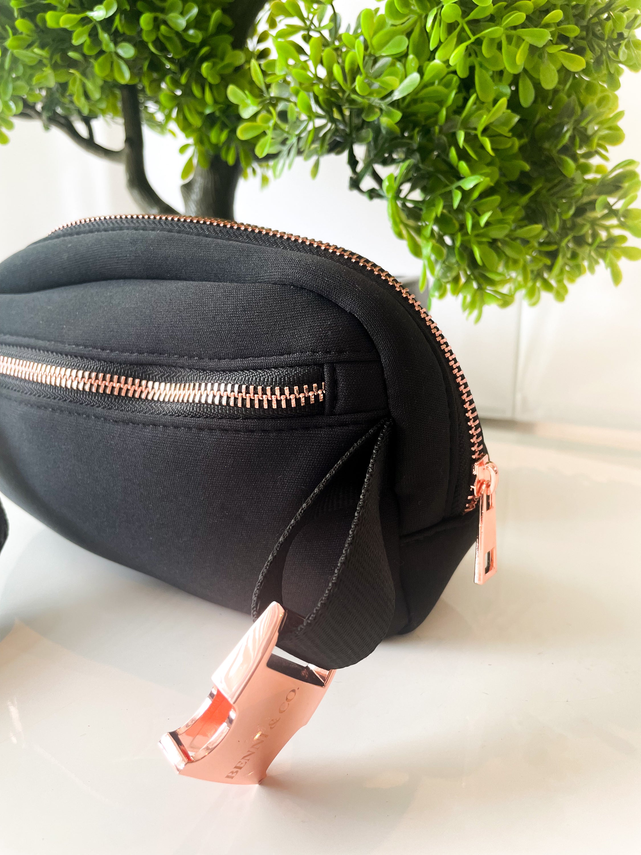 A stylish New Black Walkies Bag designed for dog parents, featuring rose gold hardware and adjustable straps.